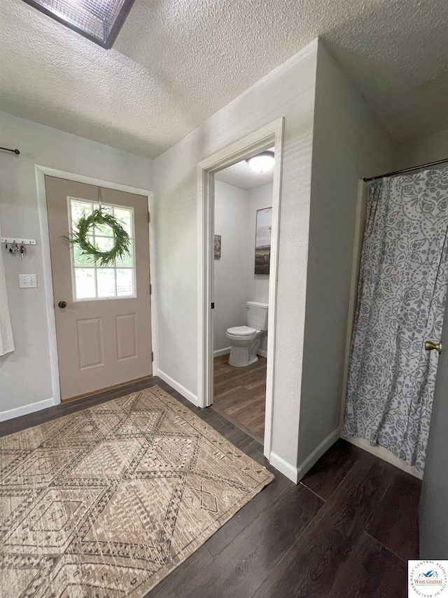 22756 Hickory Chapel Ave, Lincoln, MO 65338 - foyer entrance featuring wood finished floors, baseboards, and a textured ceiling