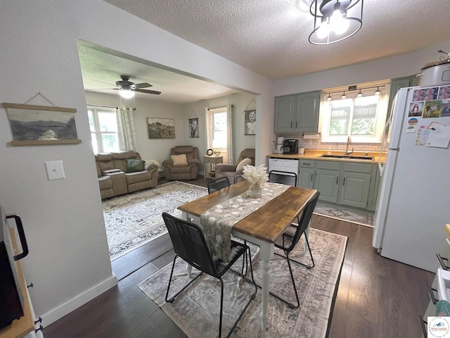 22756 Hickory Chapel Ave, Lincoln, MO 65338 - dining area with a textured ceiling, a ceiling fan, dark wood finished floors, and baseboards