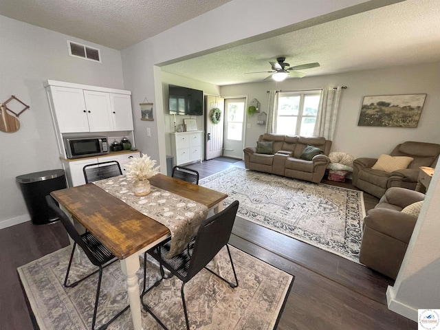 22756 Hickory Chapel Ave, Lincoln, MO 65338 - dining area with dark wood-style floors, a textured ceiling, ceiling fan, and baseboards