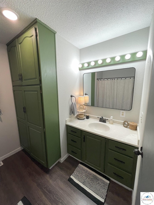 22756 Hickory Chapel Ave, Lincoln, MO 65338 - bathroom with vanity, wood finished floors, a textured ceiling, and baseboards