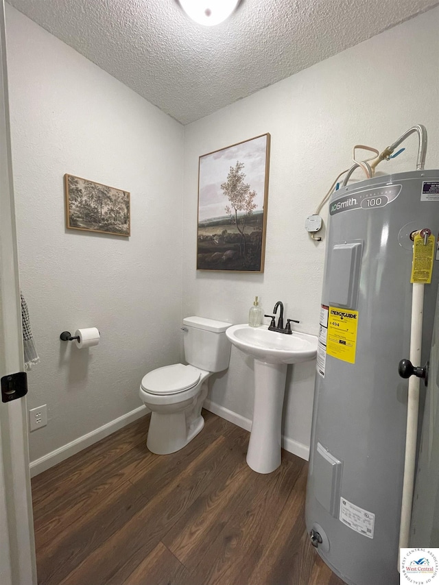 22756 Hickory Chapel Ave, Lincoln, MO 65338 - bathroom with water heater, wood finished floors, a textured ceiling, toilet, and a sink