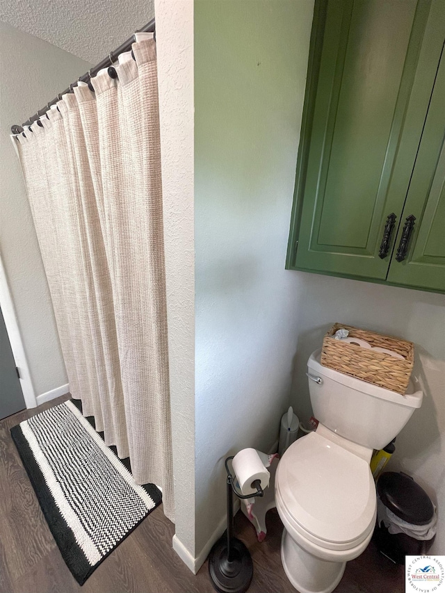 22756 Hickory Chapel Ave, Lincoln, MO 65338 - bathroom featuring toilet, wood finished floors, baseboards, and curtained shower