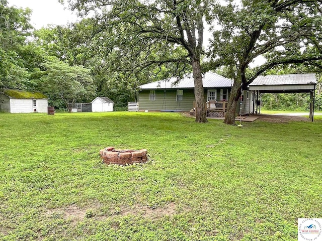 22756 Hickory Chapel Ave, Lincoln, MO 65338 - view of green lawn featuring a carport and a fire pit