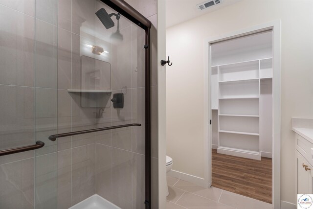 1504 E 7th St, Sedalia, MO 65301 - bathroom with a shower stall, vanity, and tile patterned flooring