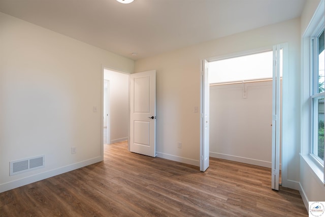 1504 E 7th St, Sedalia, MO 65301 - unfurnished bedroom featuring dark wood finished floors and a closet
