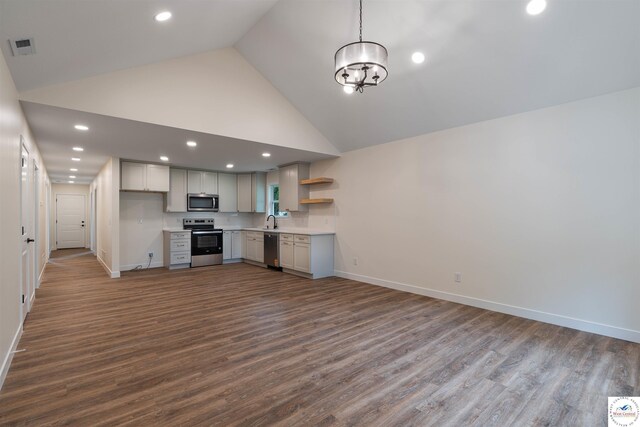 1504 E 7th St, Sedalia, MO 65301 - kitchen featuring stainless steel appliances, dark wood-type flooring, light countertops, high vaulted ceiling, and recessed lighting