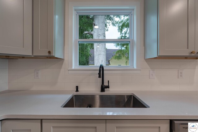 1504 E 7th St, Sedalia, MO 65301 - kitchen featuring light countertops, tasteful backsplash, and dishwasher
