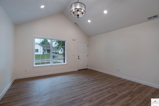 1504 E 7th St, Sedalia, MO 65301 - spare room featuring a chandelier, dark wood-type flooring, recessed lighting, and high vaulted ceiling