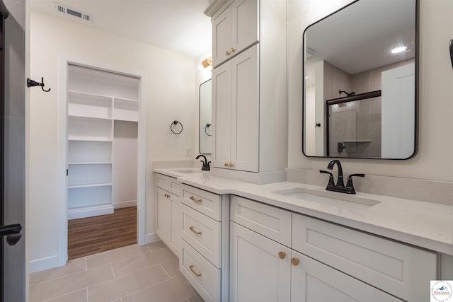 1504 E 7th St, Sedalia, MO 65301 - full bathroom with double vanity, tile patterned flooring, and a shower