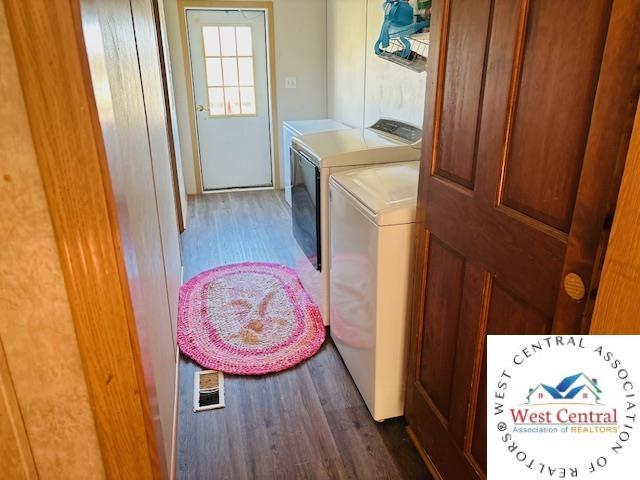 214 SE State St, Milan, MO 63556 - clothes washing area with wood finished floors, laundry area, and washing machine and dryer