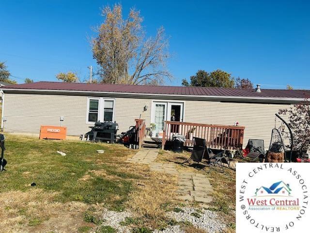 214 SE State St, Milan, MO 63556 - back of property with a deck and a yard