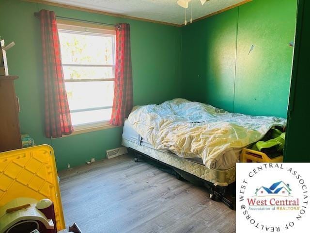 214 SE State St, Milan, MO 63556 - bedroom with wood finished floors and multiple windows