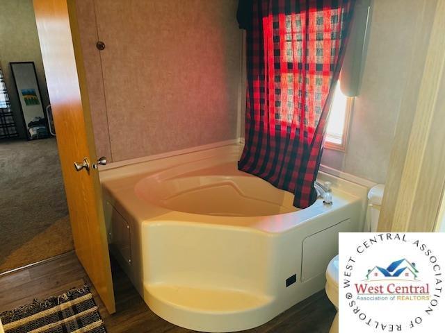 214 SE State St, Milan, MO 63556 - full bathroom with a bathing tub and toilet