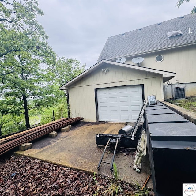 30342 Sassafras Dr, Warsaw, MO 65355 - garage featuring concrete driveway and central AC unit