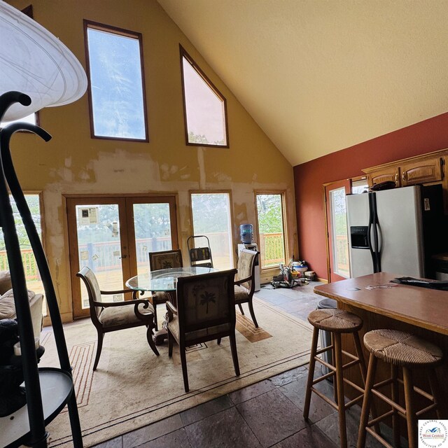 30342 Sassafras Dr, Warsaw, MO 65355 - dining room featuring high vaulted ceiling, french doors, healthy amount of natural light, and stone tile floors