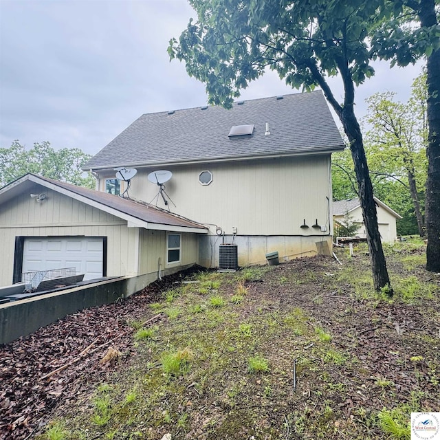 30342 Sassafras Dr, Warsaw, MO 65355 - view of property exterior with a shingled roof, central AC unit, and a garage