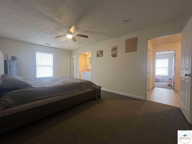 100 NW 4343 P Ln, Clinton, MO 64735 - carpeted bedroom with connected bathroom, baseboards, visible vents, a ceiling fan, and a textured ceiling