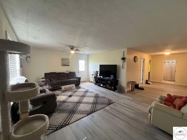 100 NW 4343 P Ln, Clinton, MO 64735 - living area with a ceiling fan, visible vents, baseboards, a textured ceiling, and wood finished floors