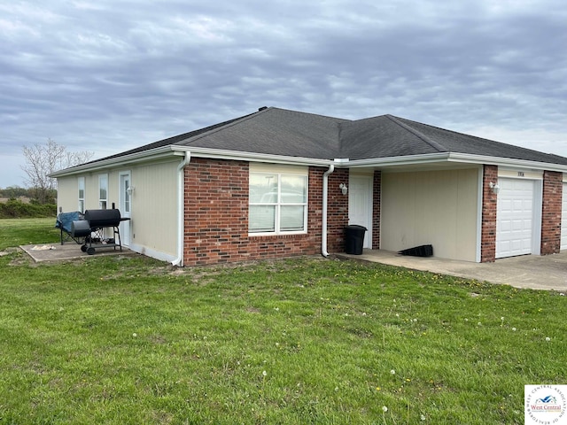 100 NW 4343 P Ln, Clinton, MO 64735 - view of property exterior featuring concrete driveway, a yard, brick siding, and an attached garage