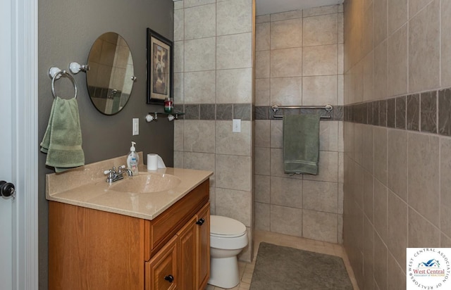 bathroom featuring toilet, tile patterned floors, and vanity
