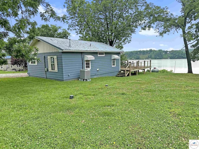 26684 Waterview Dr, Warsaw, MO 65355 - back of property with a yard, a metal roof, and a deck with water view