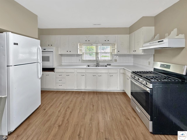 26684 Waterview Dr, Warsaw, MO 65355 - kitchen featuring white appliances, light wood-style floors, backsplash, and white cabinetry