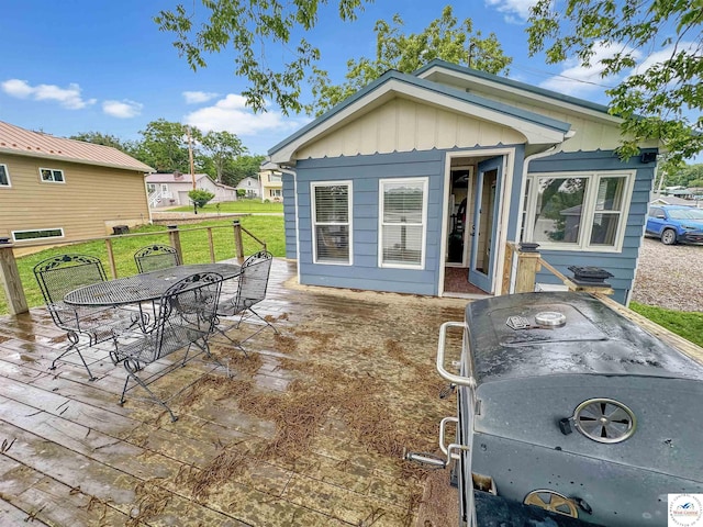 26684 Waterview Dr, Warsaw, MO 65355 - view of front of home featuring board and batten siding, outdoor dining space, and a front lawn