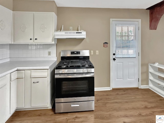 26684 Waterview Dr, Warsaw, MO 65355 - kitchen with stainless steel range with gas cooktop, range hood, light countertops, white cabinetry, and decorative backsplash