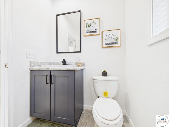 100 Mayerling Dr, Laurie, MO 65037 - bathroom with toilet, baseboards, and vanity