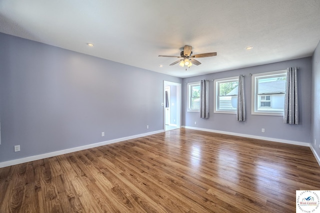 28848 Paradise Dr, Warsaw, MO 65355 - unfurnished room with baseboards, recessed lighting, ceiling fan, and wood finished floors
