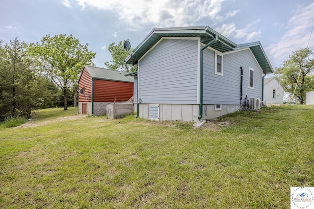28848 Paradise Dr, Warsaw, MO 65355 - view of side of property with a lawn and ac unit