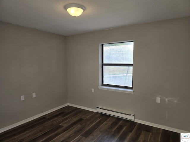 206 N Ohio St, Chilhowee, MO 64733 - empty room featuring dark wood-style floors, baseboard heating, and baseboards