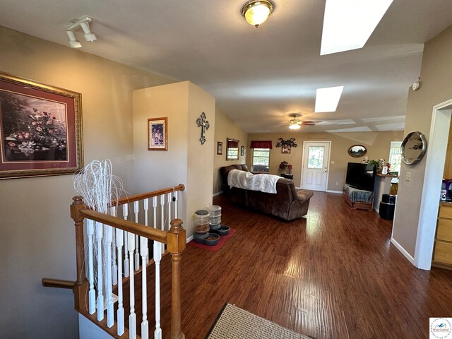 23111 Lange Rd, Cole Camp, MO 65325 - living room featuring baseboards, a skylight, ceiling fan, and dark wood-style flooring