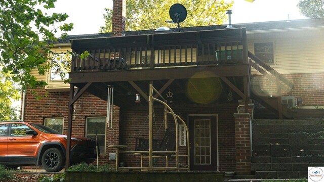 23111 Lange Rd, Cole Camp, MO 65325 - rear view of house featuring a wooden deck and brick siding