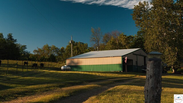 23111 Lange Rd, Cole Camp, MO 65325 - view of property exterior with metal roof, a yard, and an outbuilding