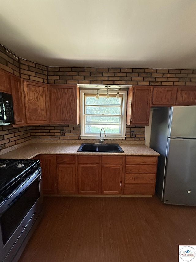 7801 Ozark Rd, Kansas City, MO 64129 - kitchen featuring freestanding refrigerator, range with gas stovetop, black microwave, and dark wood-style flooring