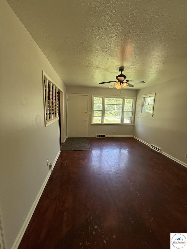 7801 Ozark Rd, Kansas City, MO 64129 - spare room with ceiling fan, wood finished floors, and a textured ceiling