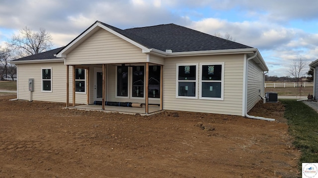 302 E Jamestown Dr, Clinton, MO 64735 - back of house featuring a patio and roof with shingles