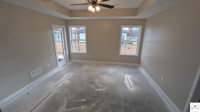 302 E Jamestown Dr, Clinton, MO 64735 - unfurnished room featuring plenty of natural light, ceiling fan, a raised ceiling, and concrete flooring