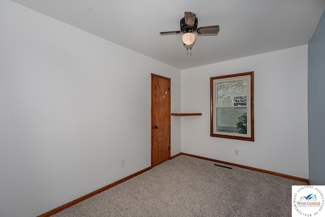unfurnished room featuring baseboards, visible vents, ceiling fan, and carpet floors