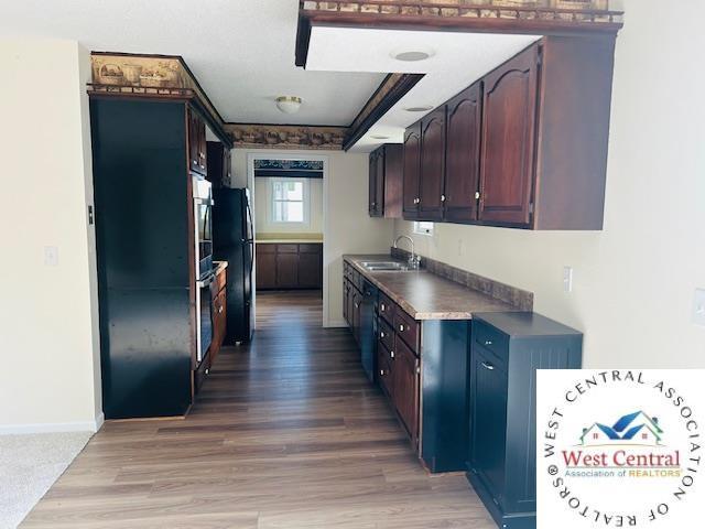 45869 E Hwy, Milan, MO 63556 - kitchen with light wood-type flooring, oven, dark countertops, and freestanding refrigerator