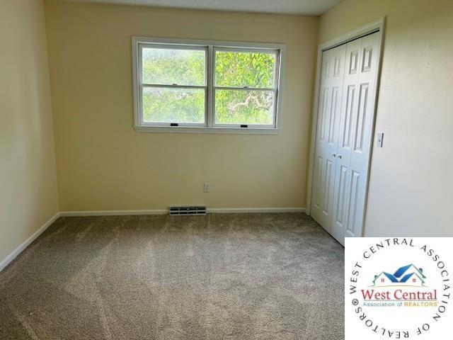 45869 E Hwy, Milan, MO 63556 - unfurnished bedroom featuring carpet and a closet