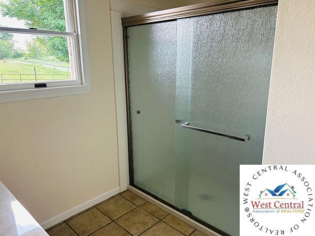 45869 E Hwy, Milan, MO 63556 - bathroom with a shower stall and tile patterned flooring