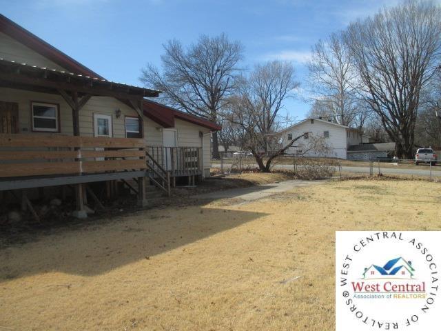 view of yard featuring a wooden deck and fence