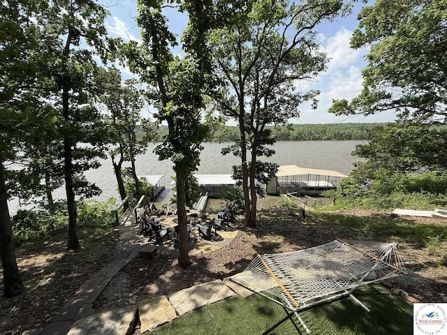 view of yard with a water view and an outdoor fire pit