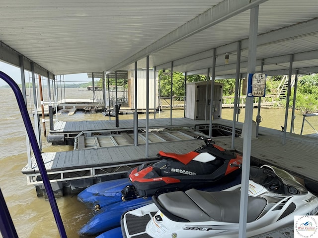 dock with boat lift and a water view