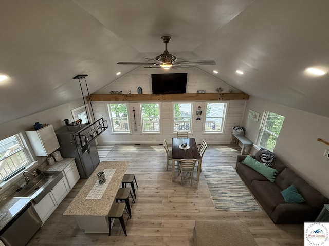 living area featuring ceiling fan, light wood-type flooring, lofted ceiling, and recessed lighting
