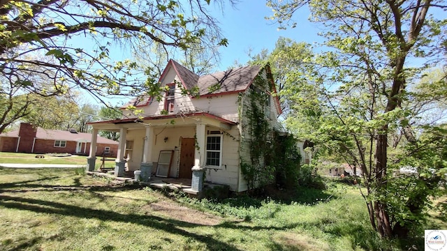207 S Olive St, Calhoun, MO 65323 - view of property exterior featuring a yard