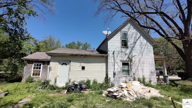 207 S Olive St, Calhoun, MO 65323 - back of house featuring a shingled roof