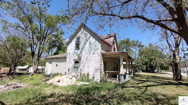 207 S Olive St, Calhoun, MO 65323 - view of property exterior featuring a yard